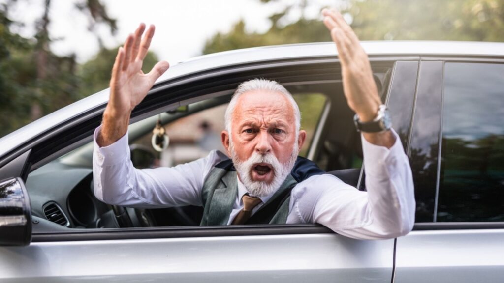Angry senior man in car