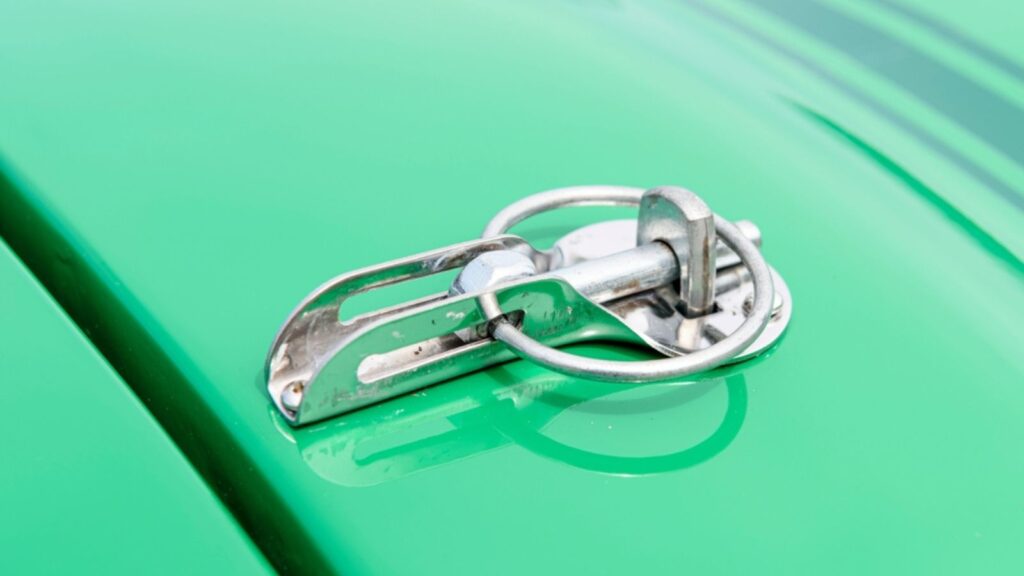 Bonnet pin on a green rally car