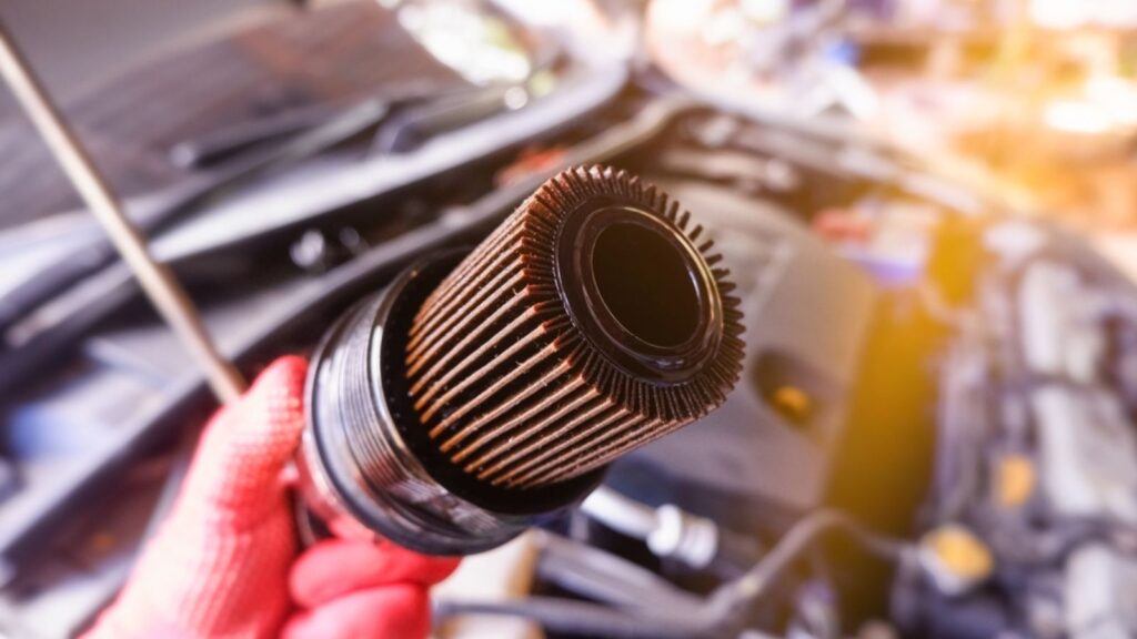 Close-up of Car paper oil filter has been used Stained with engine oil