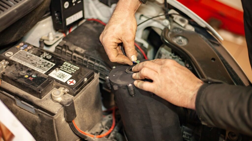 Mechanic mounts car engine hydrogen system