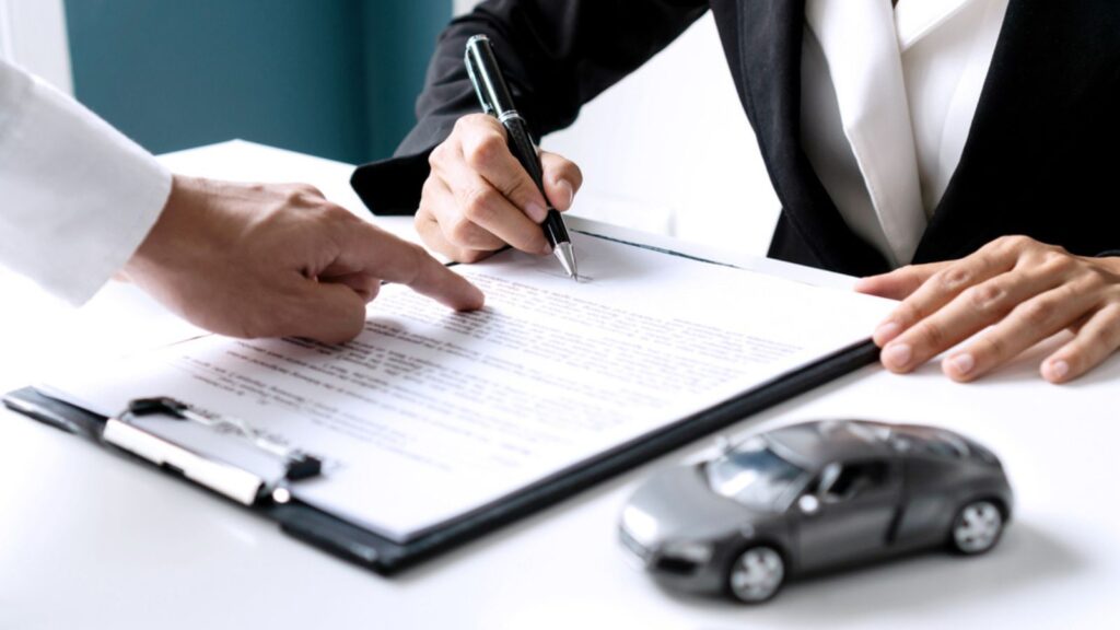 Person signing auto agreement