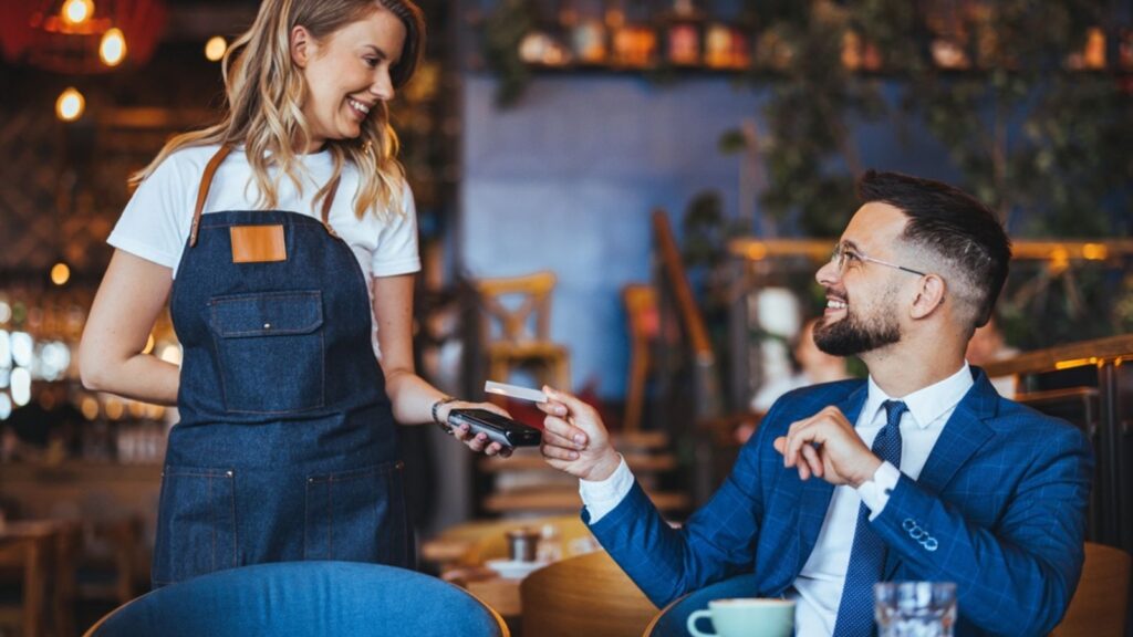 elegant man paying for dinner