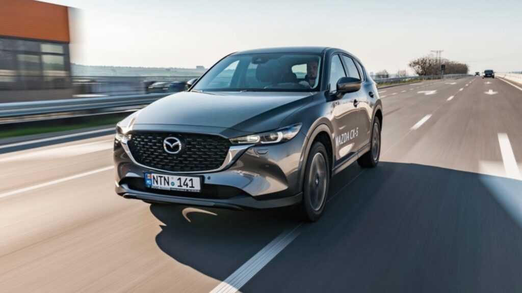 grey mazda cx-5 speeding on a highway