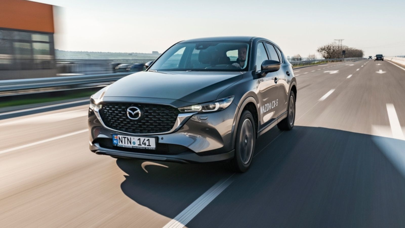 grey mazda cx-5 speeding on a highway