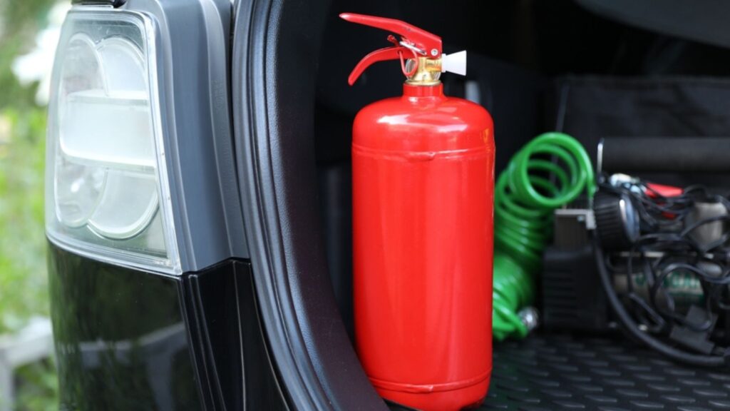 red fire extinguisher in car trunk