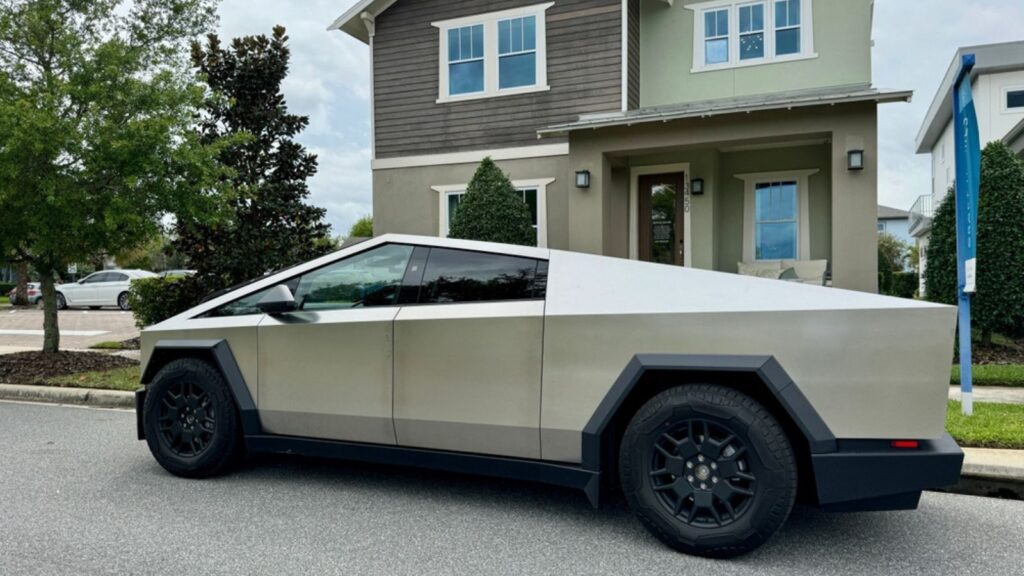 A Tesla Cybertruck in front of a home in a neighborhood parked on the street