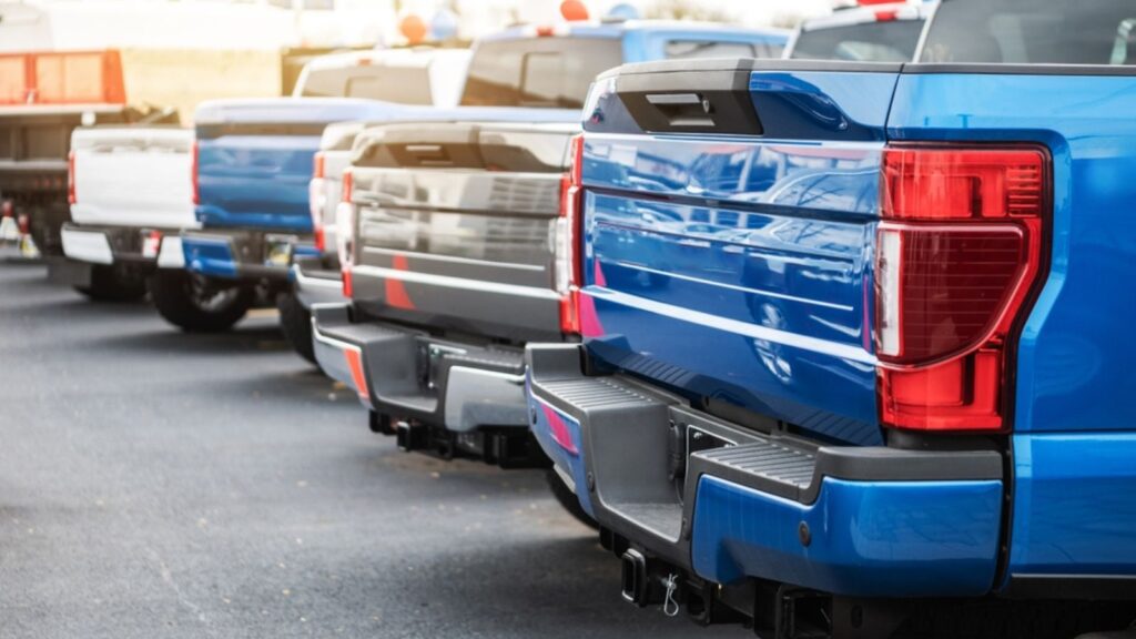 Brand New Modern Gasoline and Electric Pickup Trucks Vehicles on a Dealership Lot