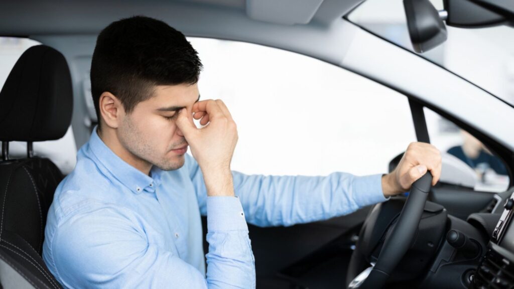 Depressed Man Sitting In Driver's Seat Of New Too Expensive Car
