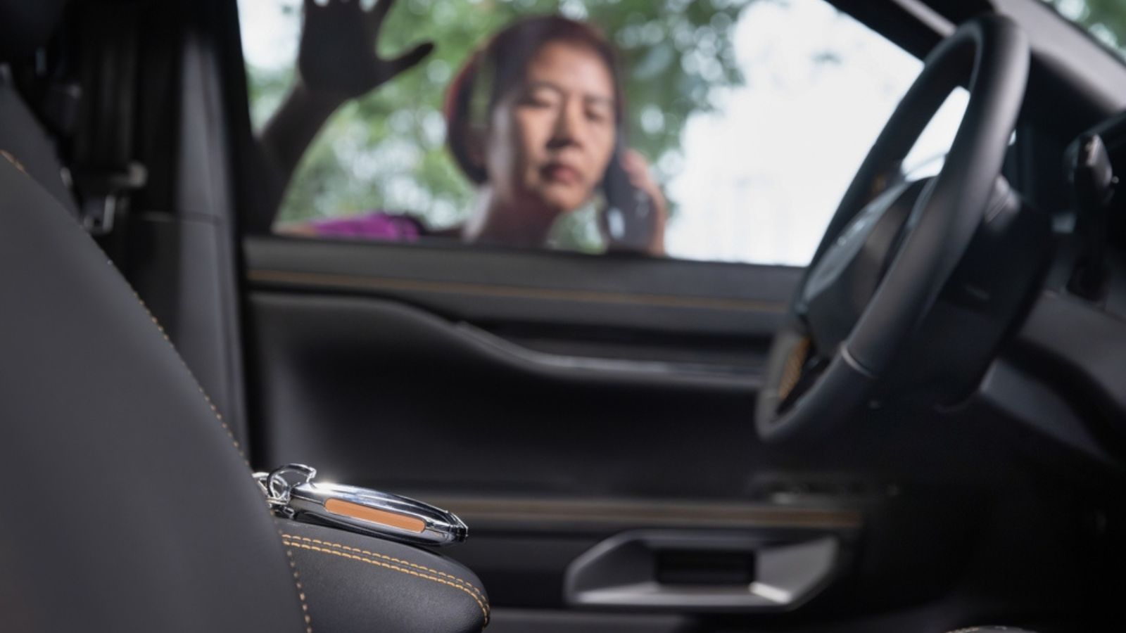 Senior asian woman forgot her key inside locked car