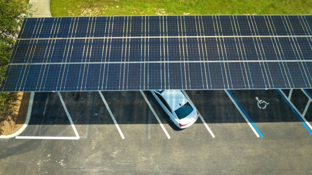Solar panels installed over parking lot for parked cars for effective generation of clean energy