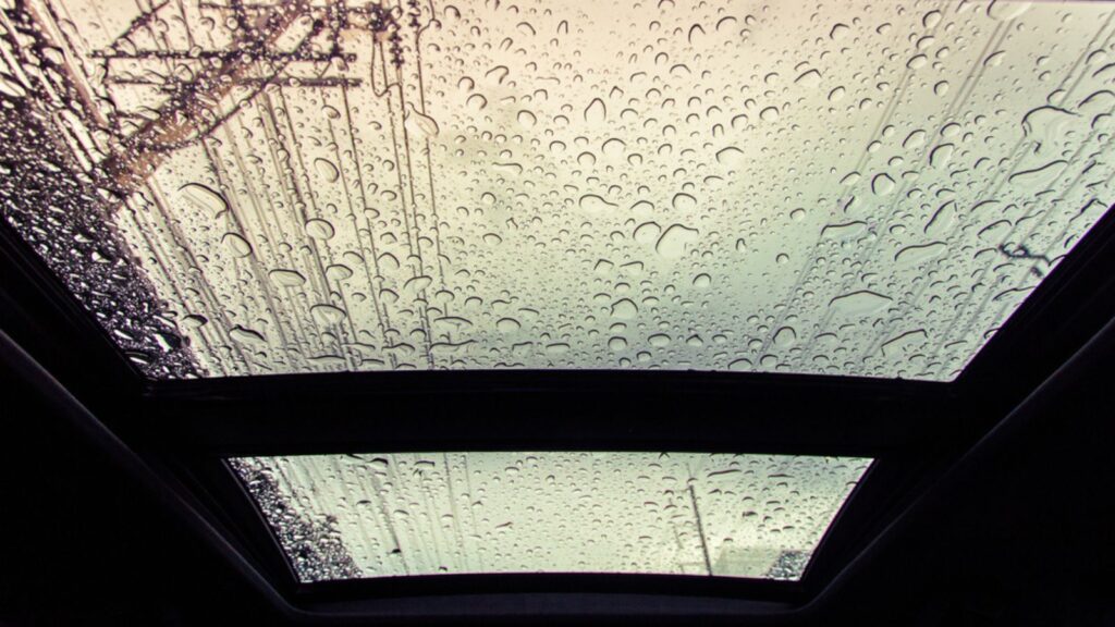 Water drops on glass of car sunroof with copy space