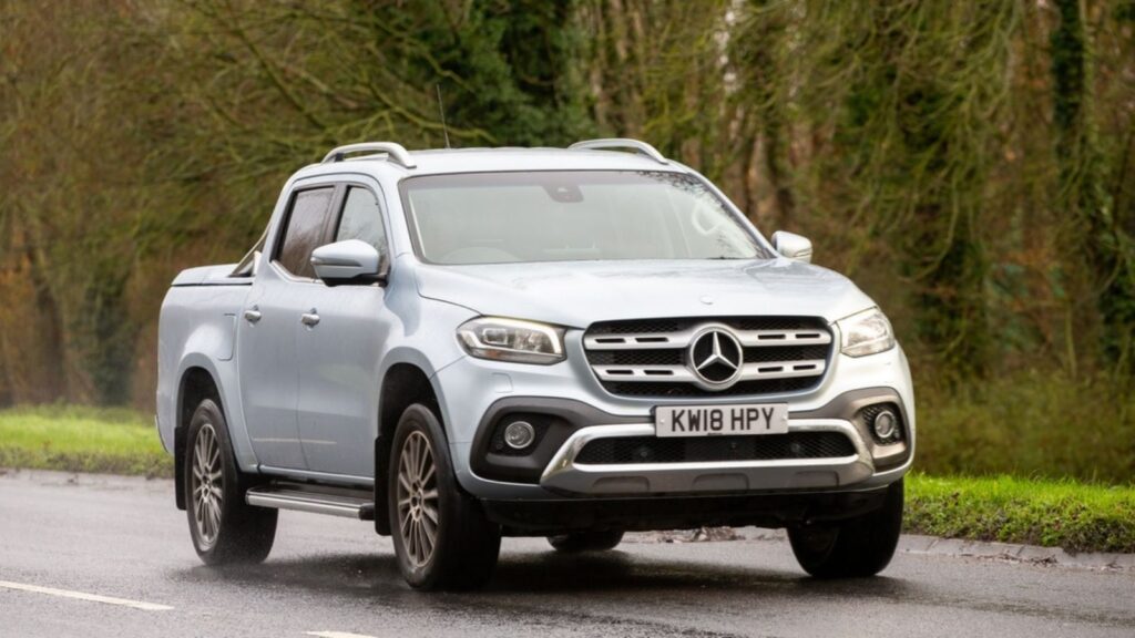2018 silver Mercedes Benz X class luxury pick up truck driving in the rain