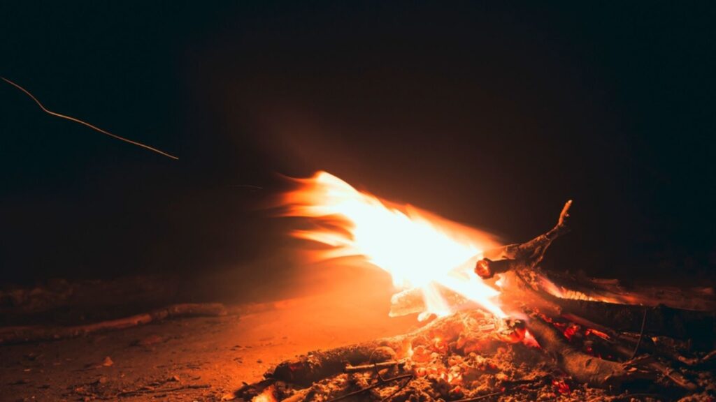 A small fire burns at night