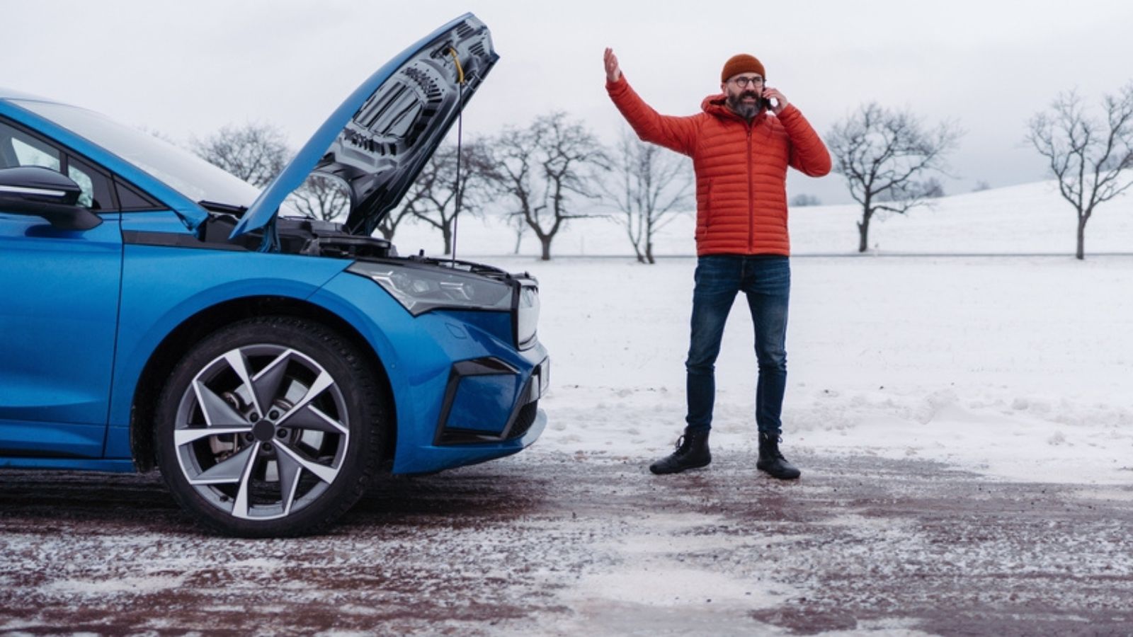 Angry man standing by electric car, battery run out of power before reaching destination