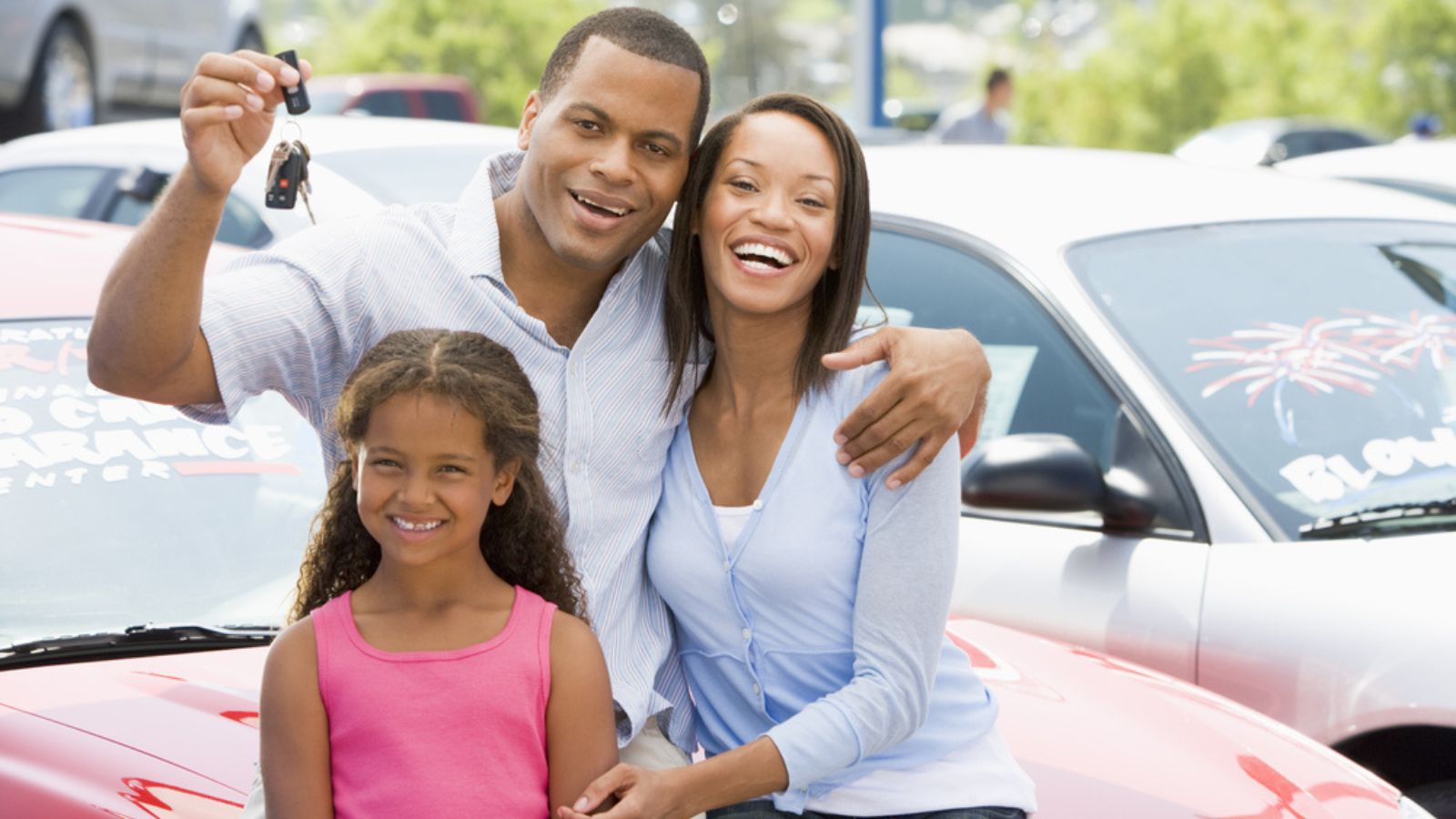 Family collecting new car from lot
