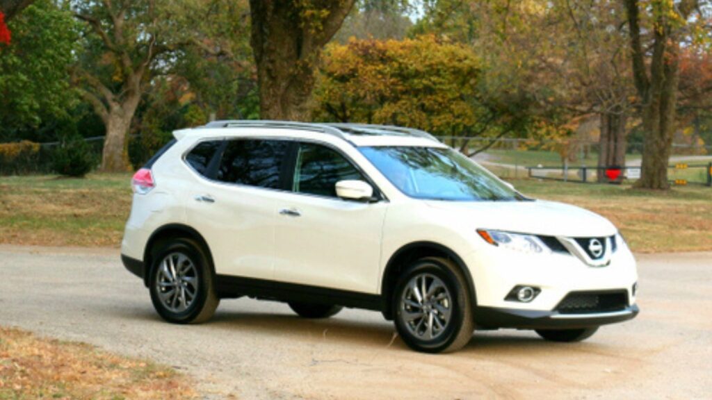 Nissan Rogue 2015 white suv parked on an empty road with huge trees on both side