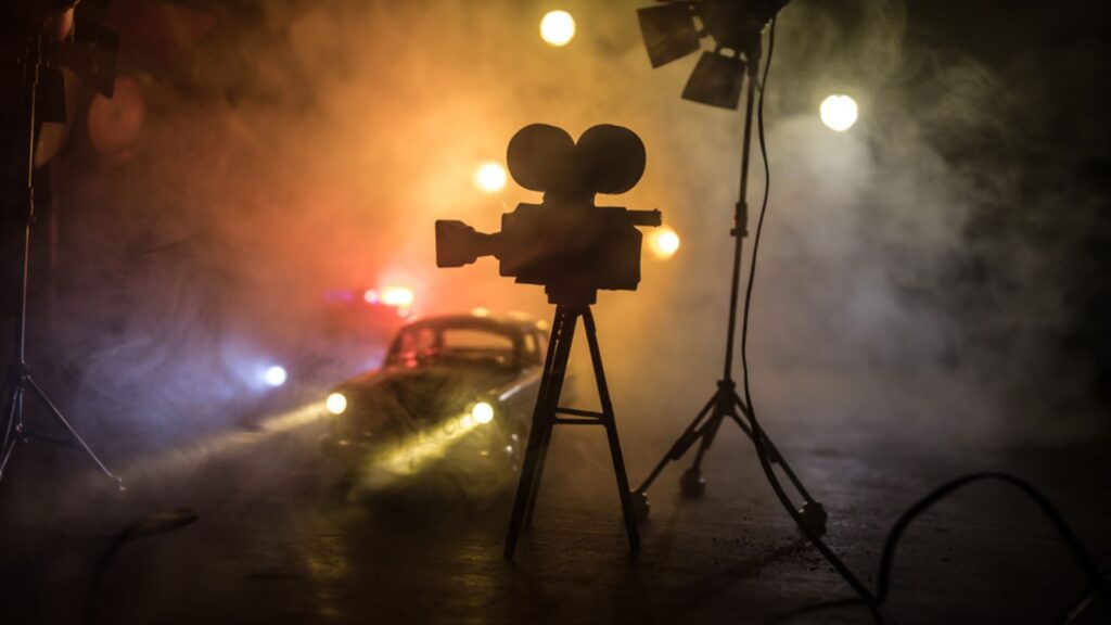 Police cars and miniature movie set on dark toned background with fog