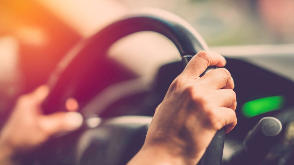 Woman hand driving car
