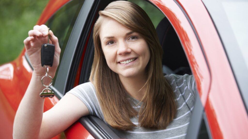 Young Female Driver In Car Holding Keys