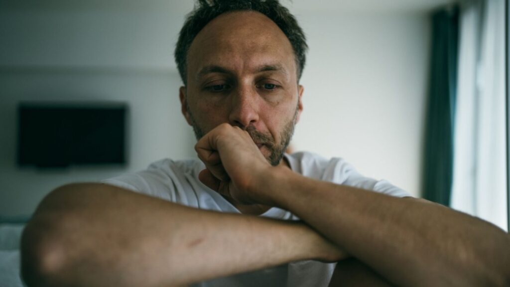 Sad middle age man alone at home